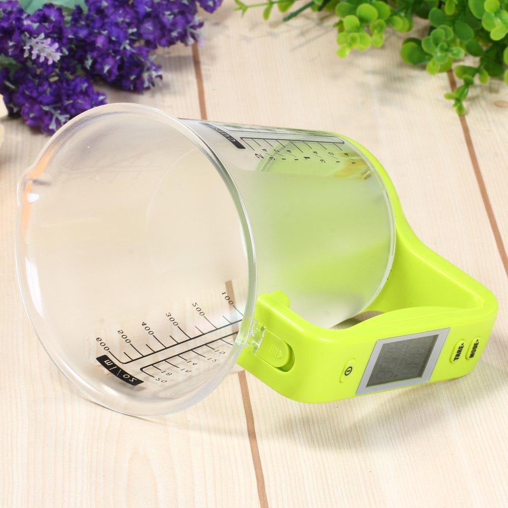 LCD kitchen scale with measuring cup in a plain product image