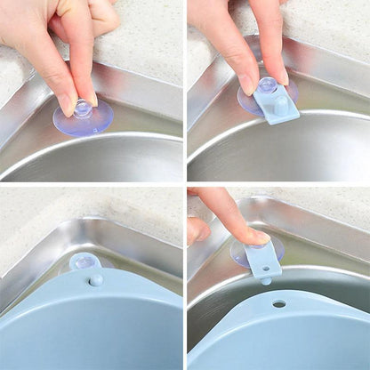 Kitchen sink drain basket organizer attached to sink with suction cups