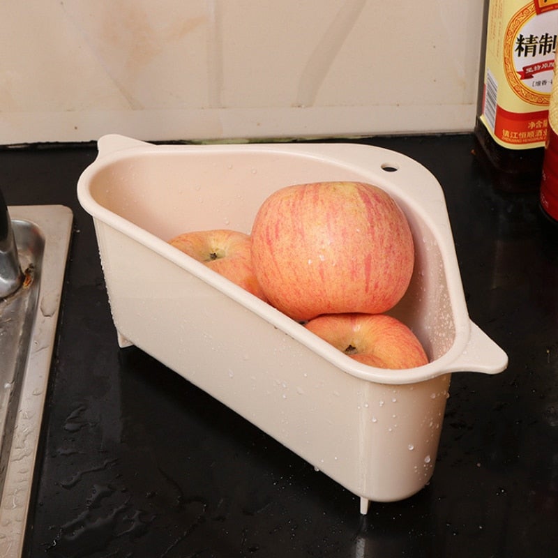 Kitchen sink drain basket organizer in use holding fresh apples