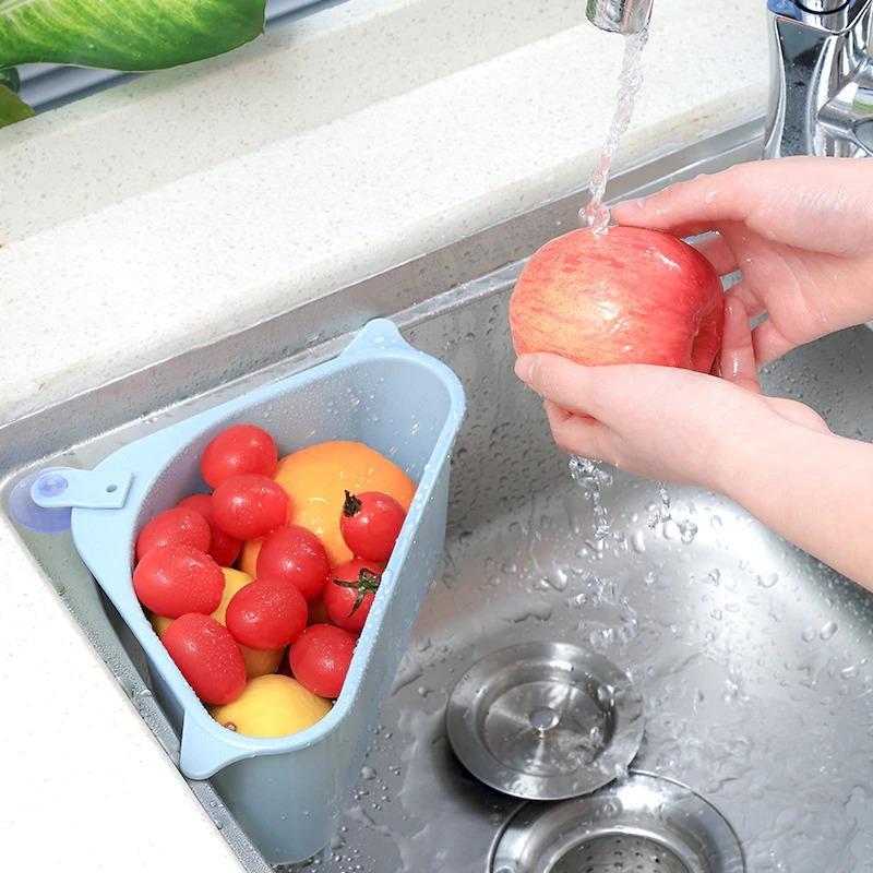 Kitchen sink drain basket organizer in use holding fresh tomatoes