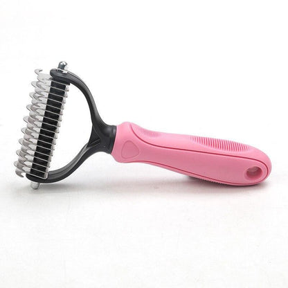 Pink brush designed for grooming pets and removing loose fur
