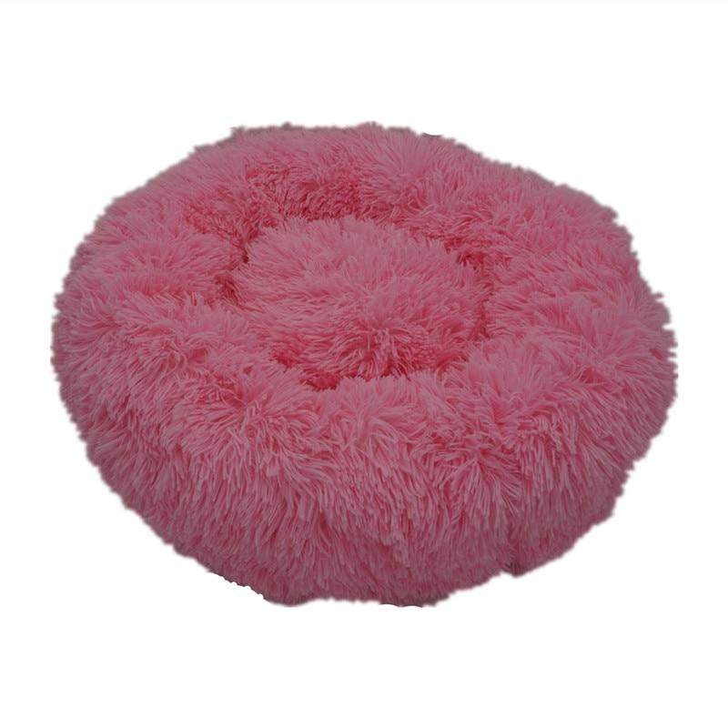 Pink calming donut bed designed for dogs and cats, providing ultra-soft comfort