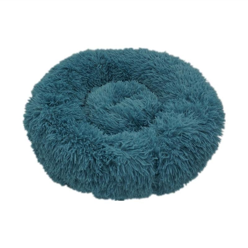 Ultra-soft teal calming donut bed for dogs and cats to relax and sleep comfortably